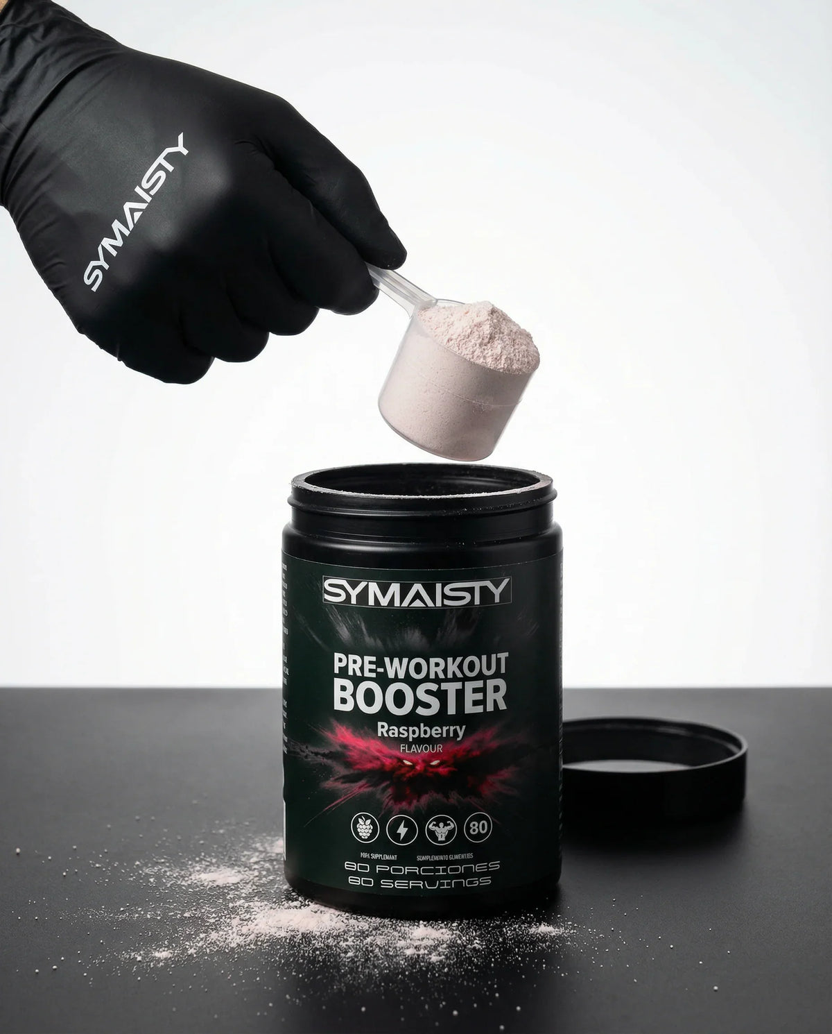 Hand scooping pink powder from Pre-Workout Booster raspberry supplement container