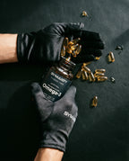 Black-gloved hands holding Omega-3 1400mg softgels bottle, capsules spilling out.