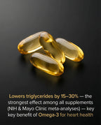 Four Omega-3 softgel capsules on black surface with heart health benefit text overlay.